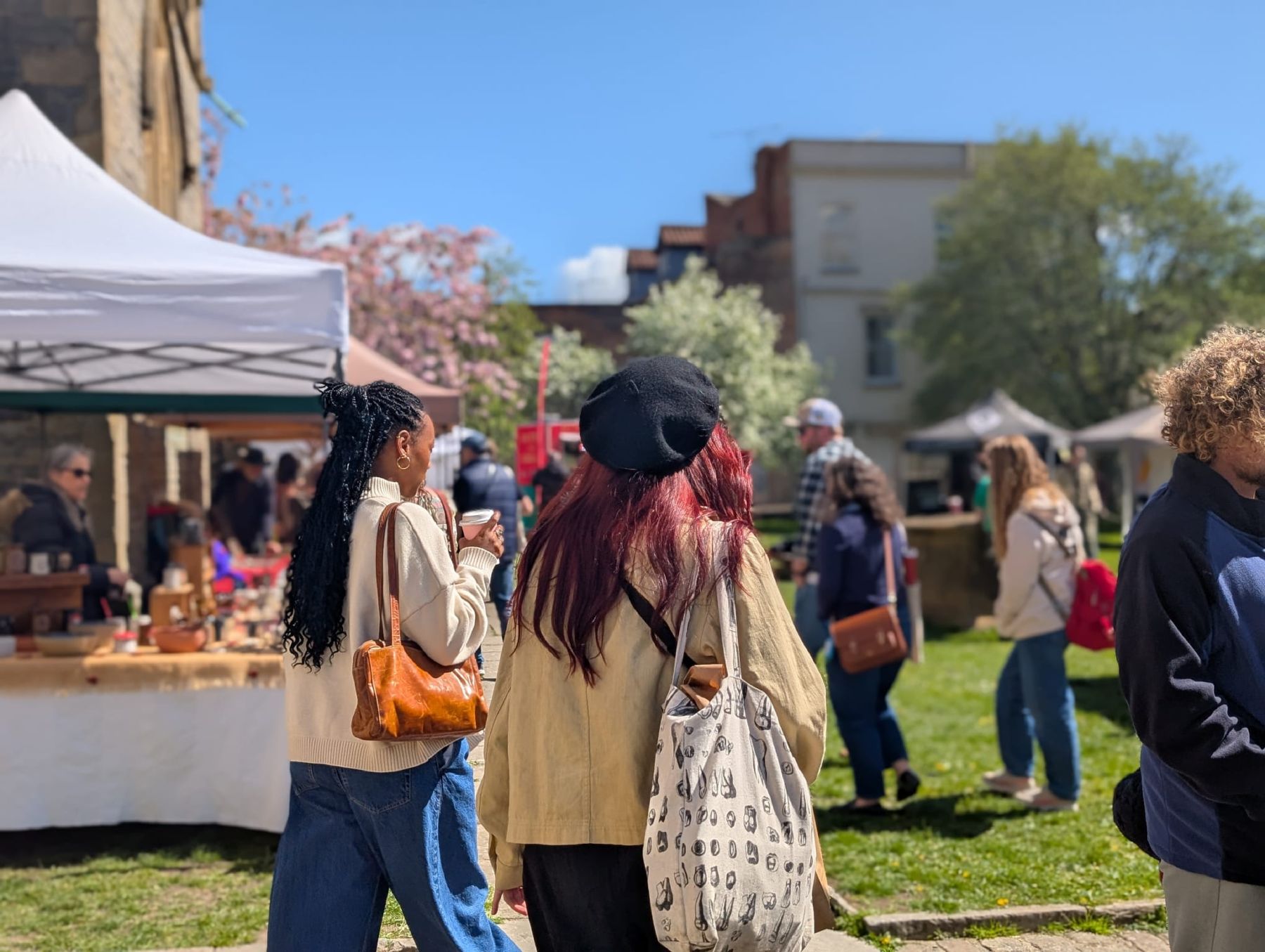 Stalls and shoppers in St John's churchyard on market day